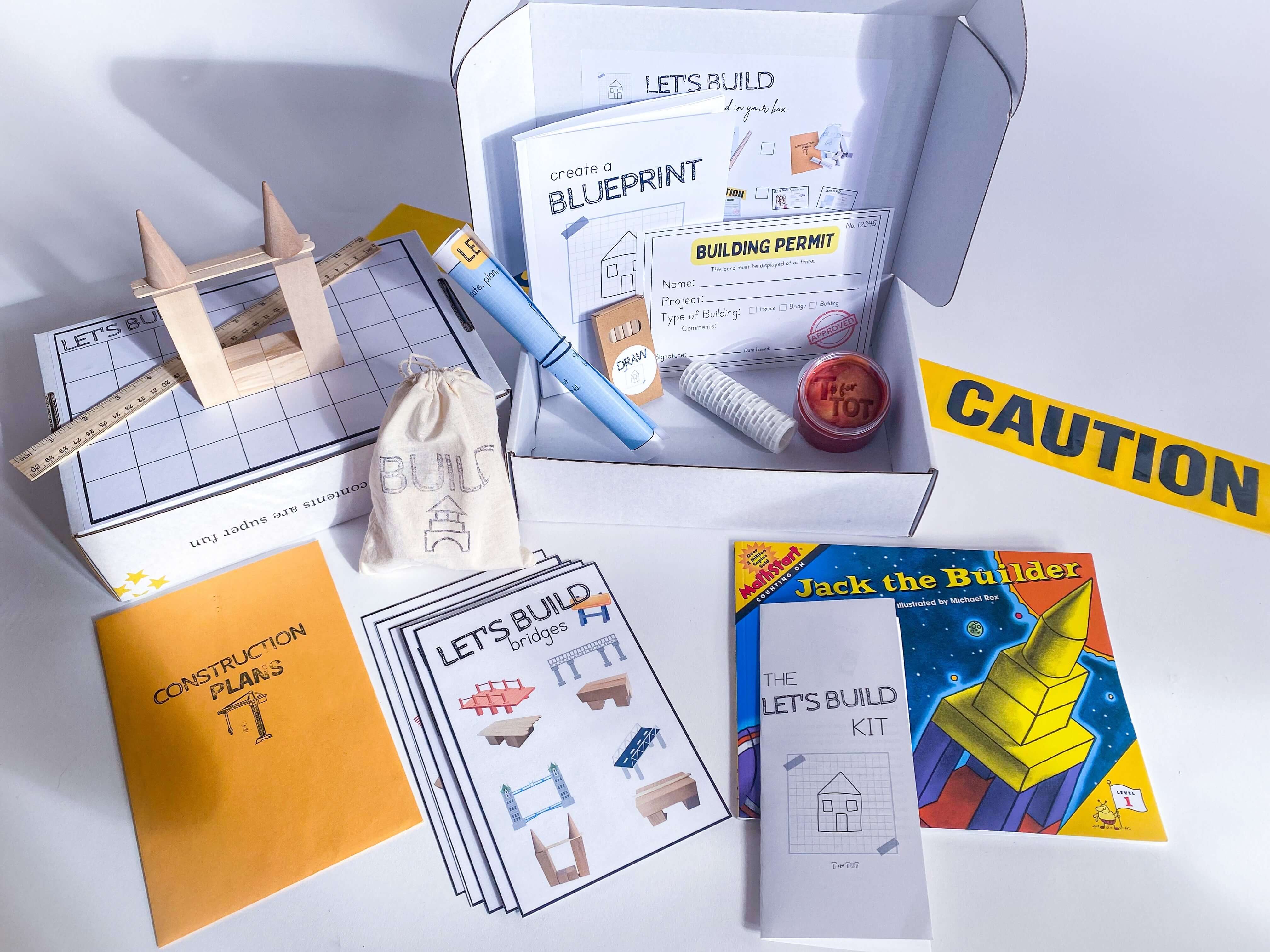 Construction play kit for kids with homemade non-toxic playdough, brick playdough roller, and building blocks. Features construction plans for educational play, role play items like blueprint and caution tape, and a blueprint journal with colored pencils and ruler.